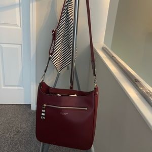 NWT never carried Henri Bendel Bowery Messenger Bag. Color is a deep burgundy.